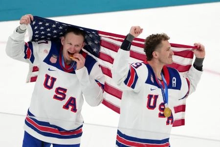 Feb 22, 2026; Milan, Italy; Brady Tkachuk and Matthew Tkachuk of the United States celebrate after winning the men's ice hockey gold medal game during the Milano Cortina 2026 Olympic Winter Games at Milano Santagiulia Ice Hockey Arena. Mandatory Credit: James Lang-Imagn Images