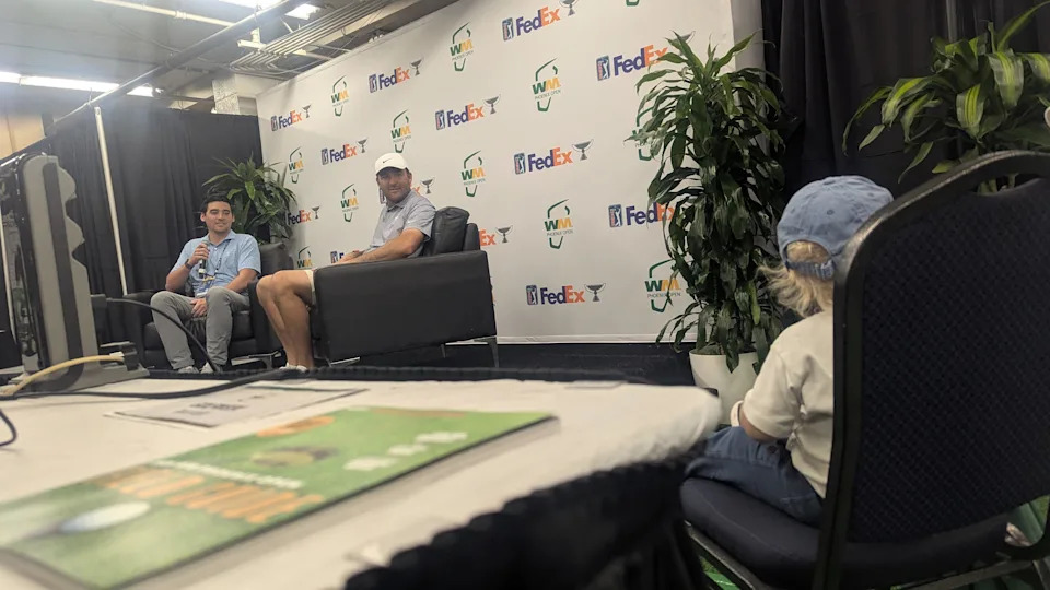 Bennett Scheffler sits in a chair during his dad Scottie's news conference ahead of the 2026 WM Phoenix Open at TPC Scottsdale.