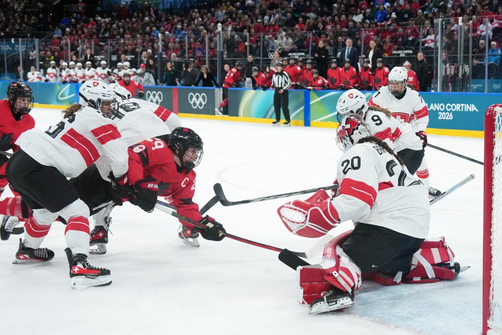 Canada's Marie-Philip Poulin (29) scores past Switzerland's Andrea Braendli (20) during second period women's Olympic semifinal hockey action at the 2026 Milan Cortina Winter Olympics in Milan, Monday, Feb. 16, 2026. THE CANADIAN PRESS/Nathan Denette