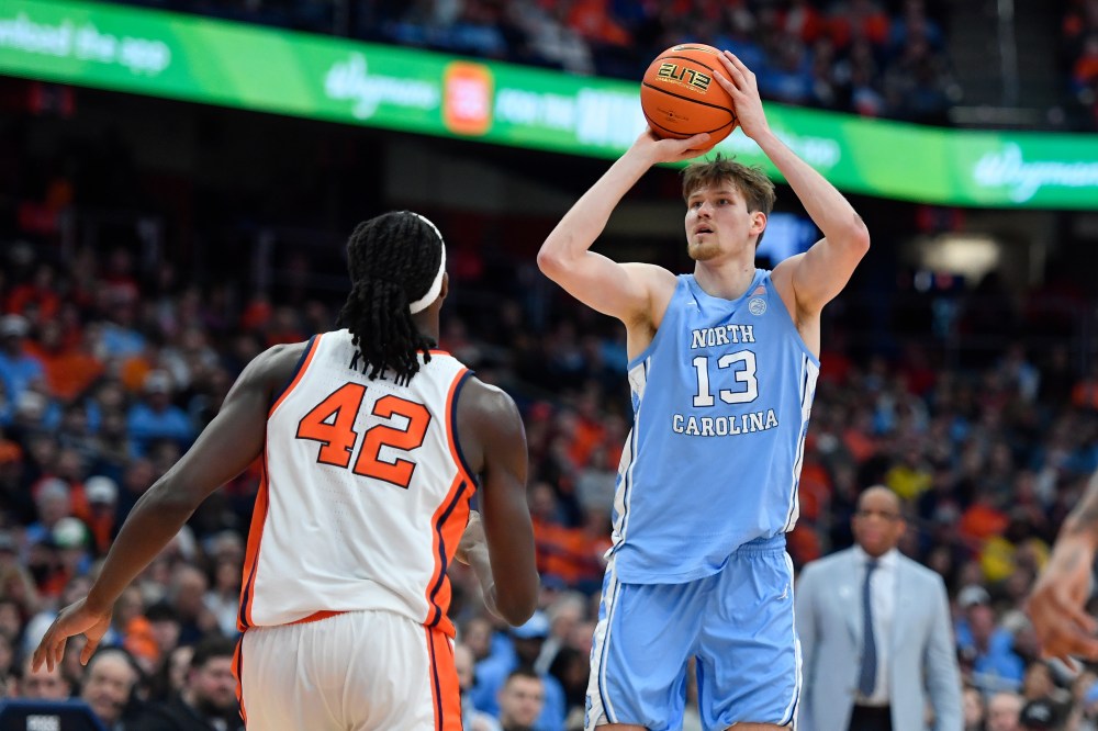 North Carolina center Henri Veesaar (13) shoots over Syracuse forward William Kyle III (42) during the first half of an NCAA college basketball game Saturday, Feb. 21, 2026, in Syracuse, N.Y. (AP Photo/Adrian Kraus)
