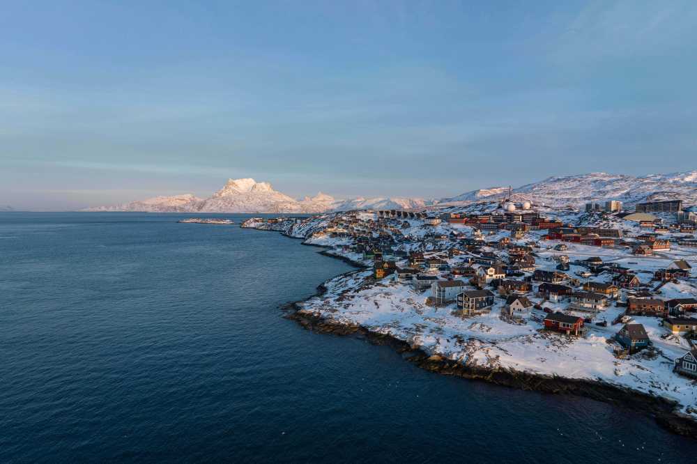 FILE - Houses are seen near the coast of a sea inlet of Nuuk, Greenland, on Sunday, Jan. 25, 2026. (AP Photo/Evgeniy Maloletka, File)