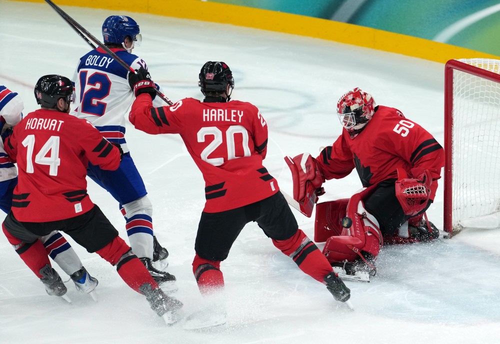 Canada goalie Jordan Binnington (50) makes a save on United States' Matt Boldy (12) during the third period of the men's gold medal hockey game at the 2026 Winter Olympics, in Milan, on Sunday, Feb. 22, 2026. THE CANADIAN PRESS/Darryl Dyck