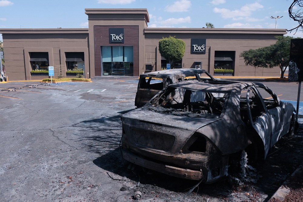 Charred vehicles sit in a parking lot sit outside a shopping mall in Guadalajara, Jalisco state, Mexico, Sunday, Feb. 22, 2026, as authorities reported that the Mexican Army killed Jalisco New Generation Cartel leader Nemesio Oseguera, known as