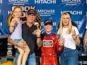 In this undated image provided by Kevin Harvick, Inc., Keelan Harvick, center, poses with his family, from left, sister Piper, father retired NASCAR driver Kevin Harvick and mother DeLana Harvick following a victory.