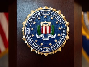 An FBI seal is displayed on a podium.