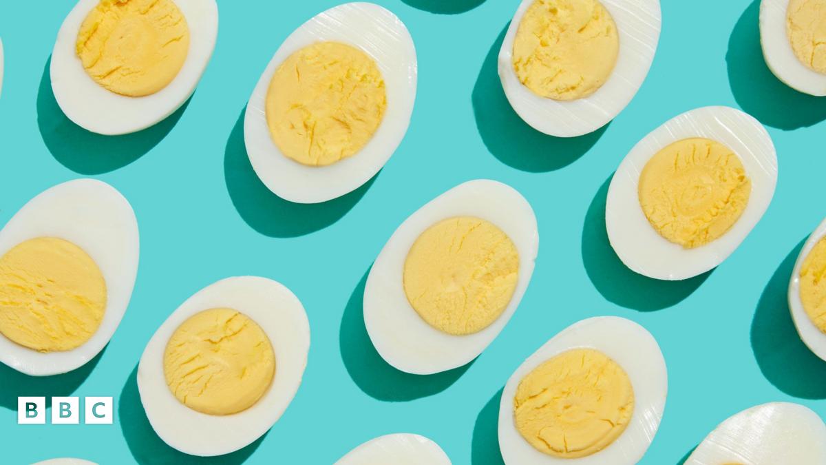 Halved hard-boiled eggs on a light blue background