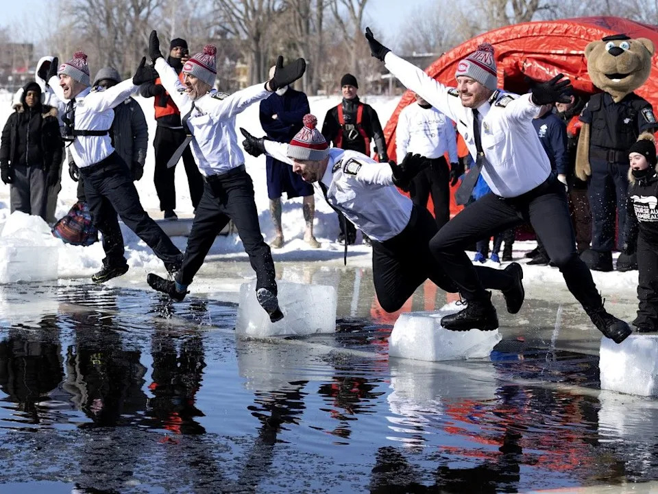 Members of the Montreal police force jump into the water during their annual polar plunge in Montreal.