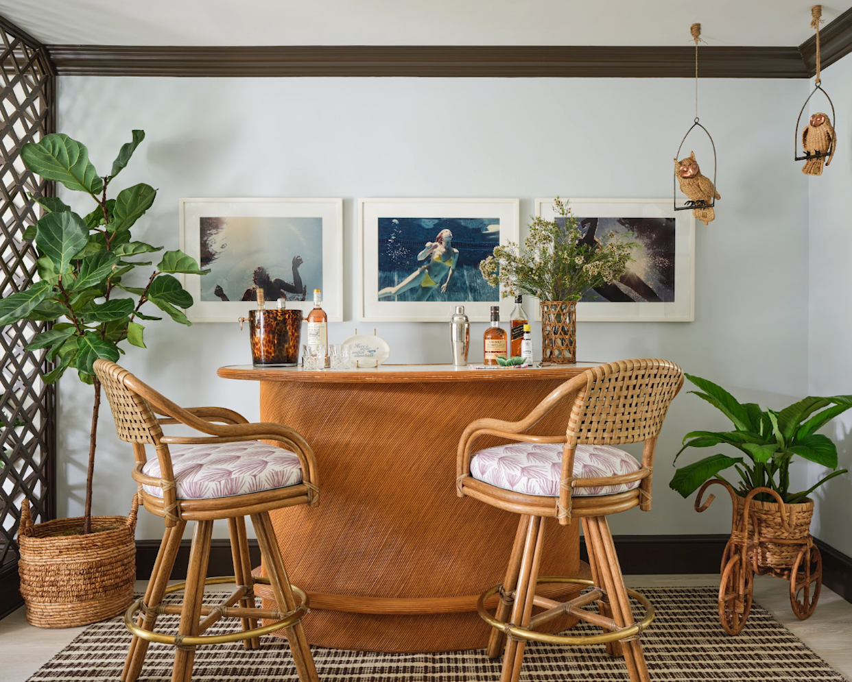 Home bar setup with stools and decorative elements.