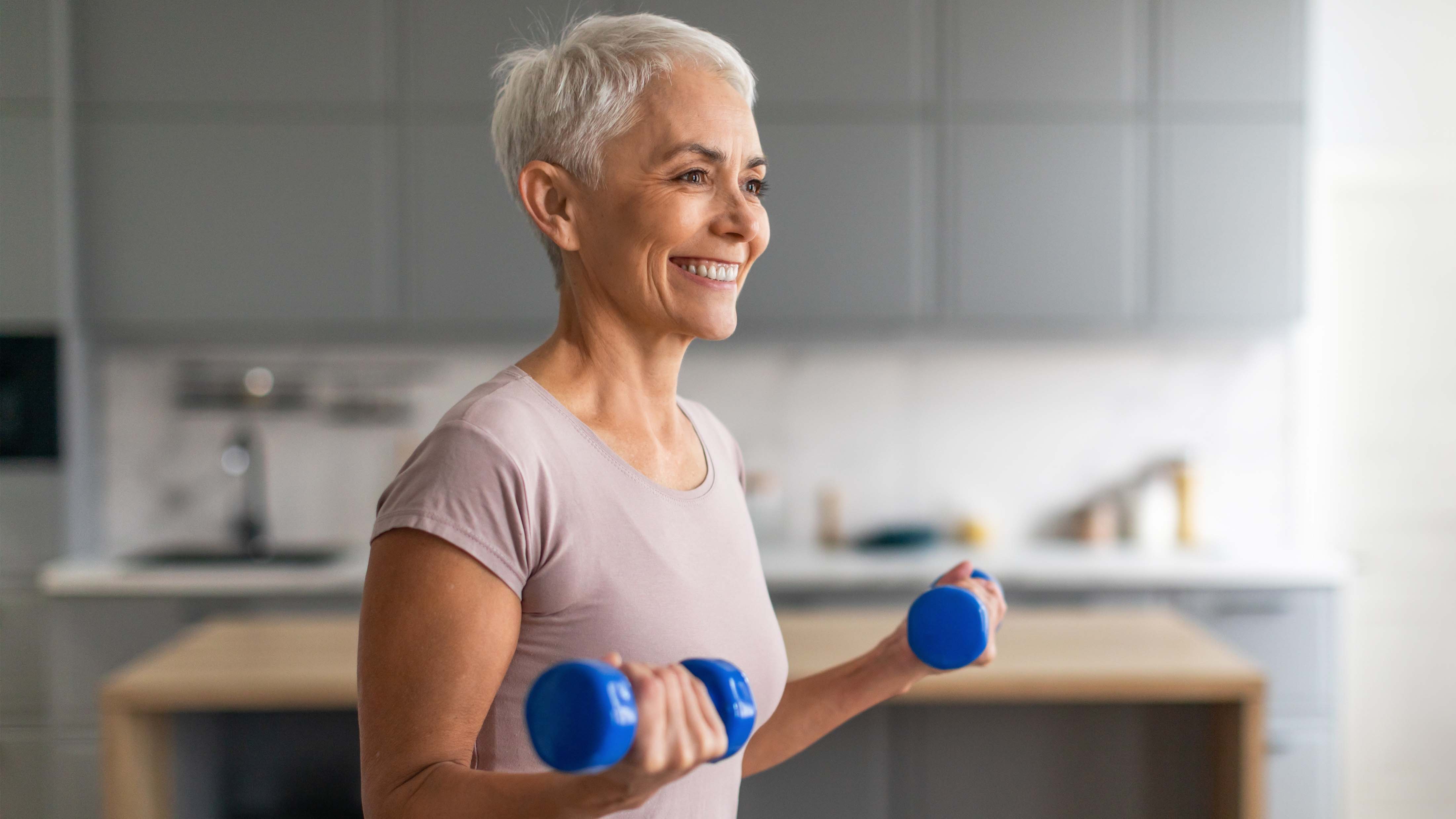 a photo of a woman holding a set of dumbbells