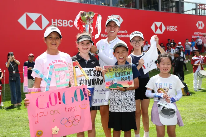 Lydia Ko of New Zealand poses with young fans and the trophy on the 18th green following victory on Day Four of the HSBC Women's World Championship 2025 at Sentosa Golf Club on March 02, 2025 in Singapore.