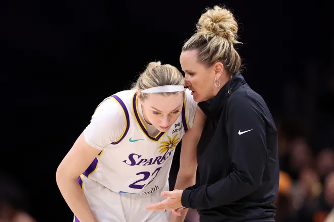Head coach Lynne Roberts talks to Cameron Brink of the Los Angeles Sparks.