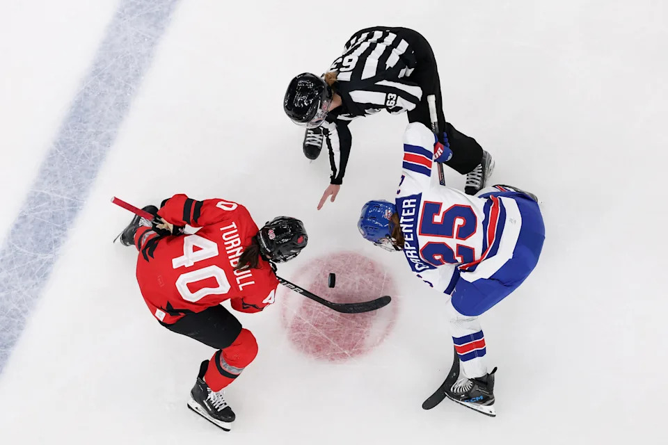 MILAN, ITALY - FEBRUARY 10: (EDITOR'S NOTE: Image was captured using a remote camera positioned above the field of play.) Blayre Turnbull #40 of Team Canada and Alex Carpenter #25 of Team United States face off during the Women's Preliminary Group A match between United States and Canada on day four of the Milano Cortina 2026 Winter Olympic games at Milano Santa Giulia Ice Hockey Arena on February 10, 2026 in Milan, Italy. (Photo by Jared C. Tilton/Getty Images)