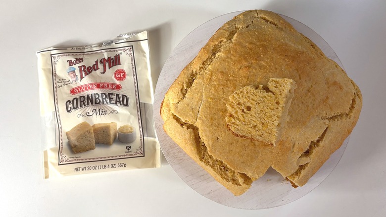 Bag of Bob's Red Mill Gluten Free cornbread mix on table next to cornbread