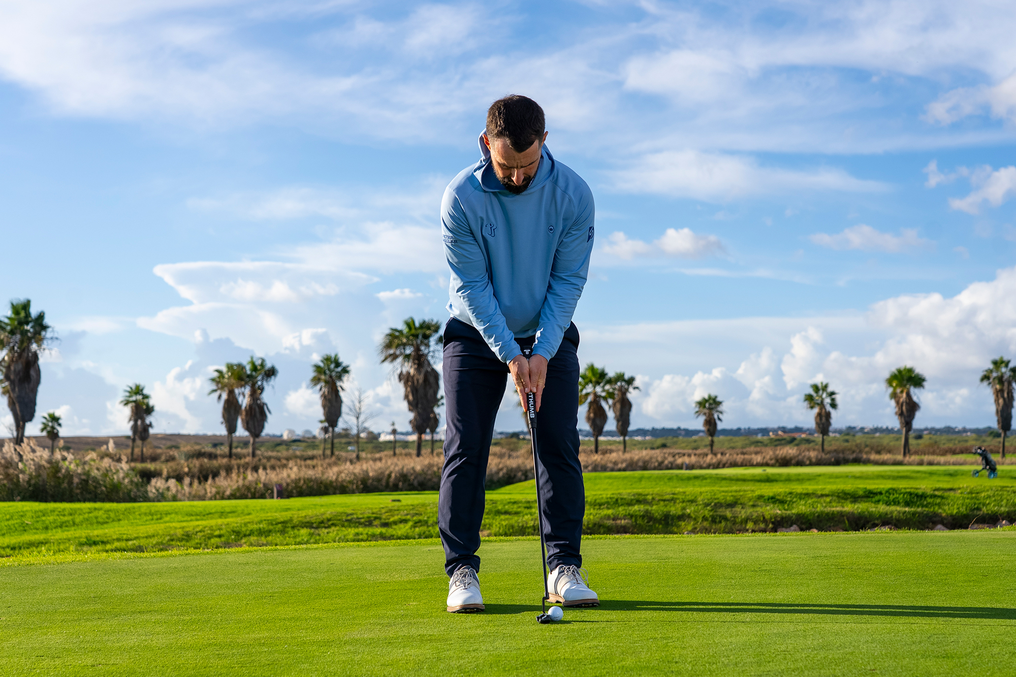 James Jankowski demonstrating the prayer putting grip with both hands facing inwards and level on the grip