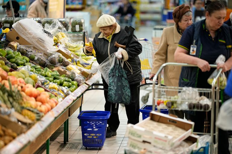 People buy fruits at a hypermarket in Moscow, Russia, on Nov. 3, 2023. The shelves at Moscow supermarkets are full of fruit and vegetables, cheese and meat. But many of the shoppers look at the selection with dismay as inflation makes their wallets feel empty. (AP Photo)