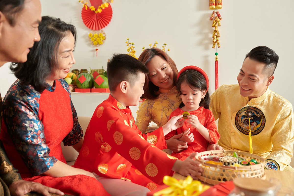 Family celebrating Lunar New Year by sharing treats.