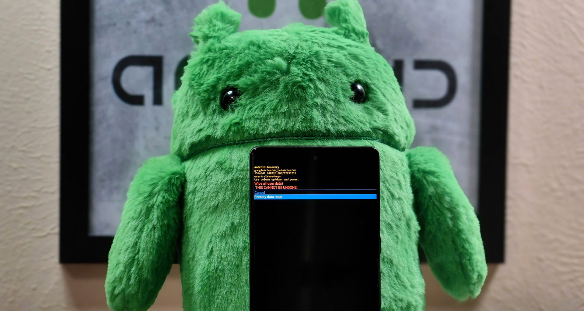 Photo of a Pixel 7 Pro in recovery mode in front of an Android plushie