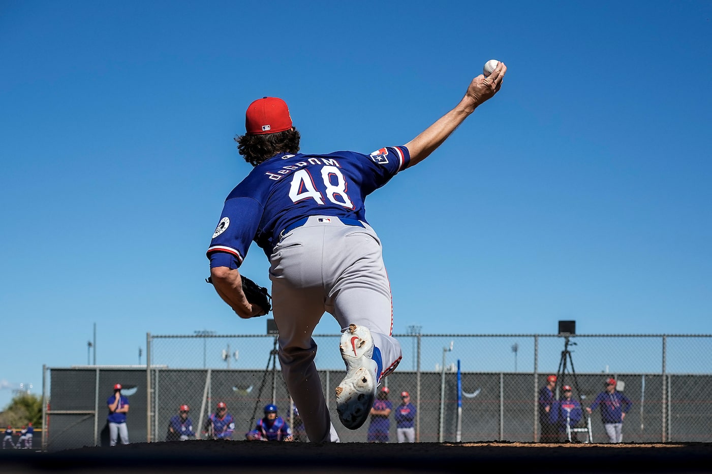 Texas Rangers pitcher Jacob Degrom throws in the bullpen during a spring training workout at...