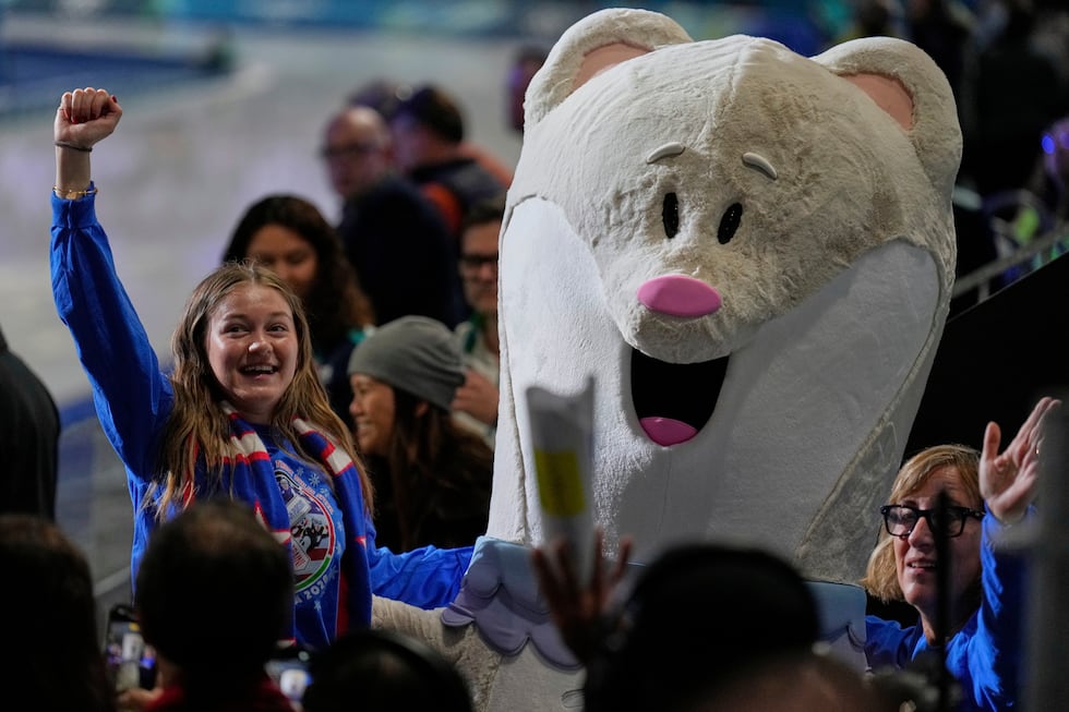 Fans cheer with the mascot prior to the team pursuit speedskating races at the 2026 Winter...