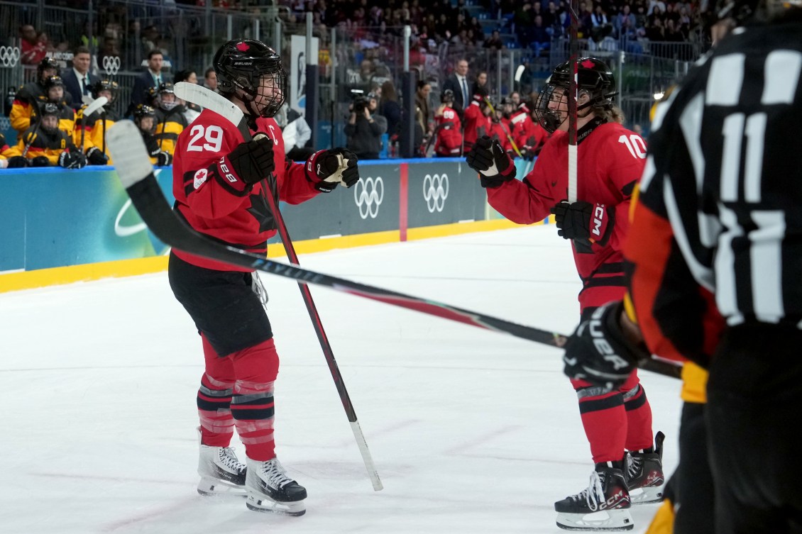 Canada’s Marie-Philip Poulin celebrates her goal with teammate Sarah Fillier.