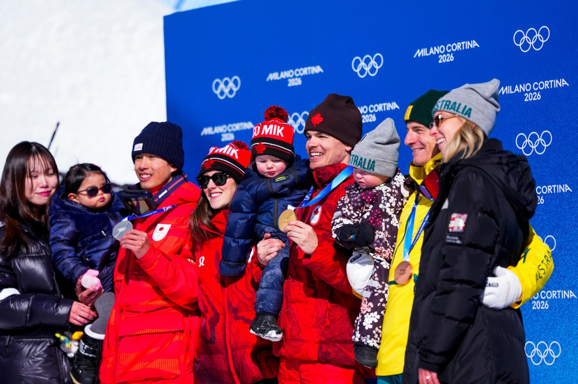 Team Canada’s Mikael Kingsbury celebrates with his family after winning a gold medal in the Men's Dual Moguls Finals