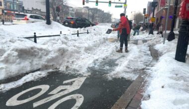 Cyclists clear snow from Comm. Ave. bike lanes, urge city action