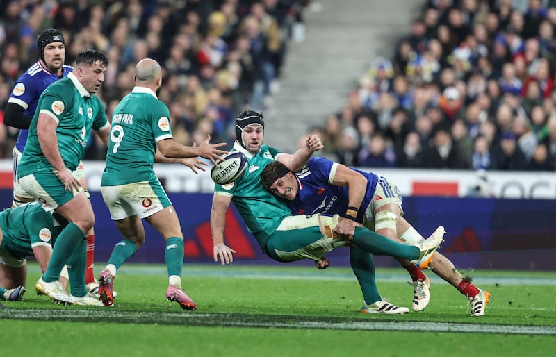 Ireland's Caelan Doris passes to Jamison Gibson-Park as he is tackled by France's Oscar Jegou. Photograph: Inpho
