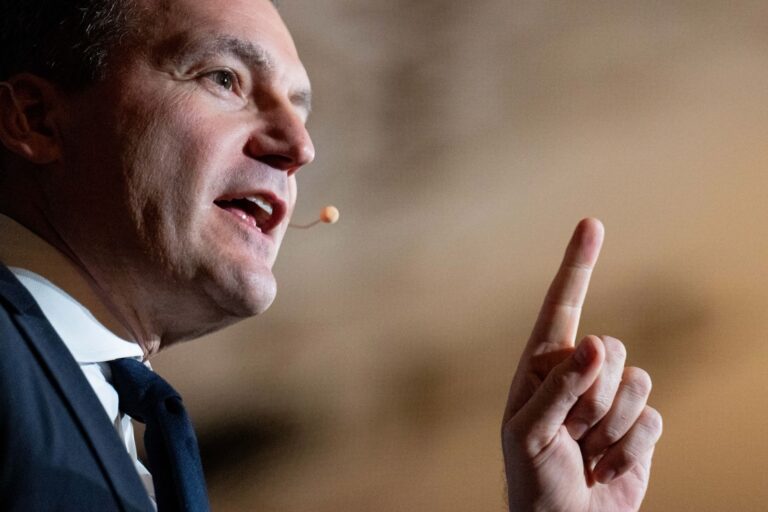 Close-up picture of Evan Solomon in profile, speaking while holding up a finger.