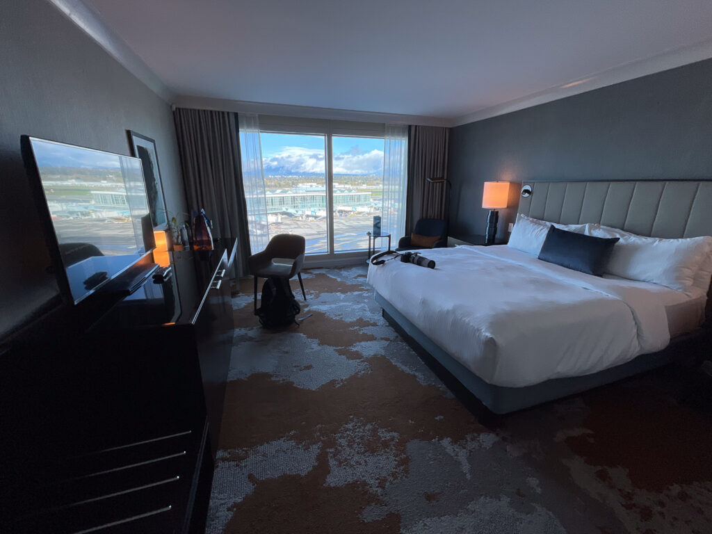 A large bed is seen as you walk into the hotel room. 