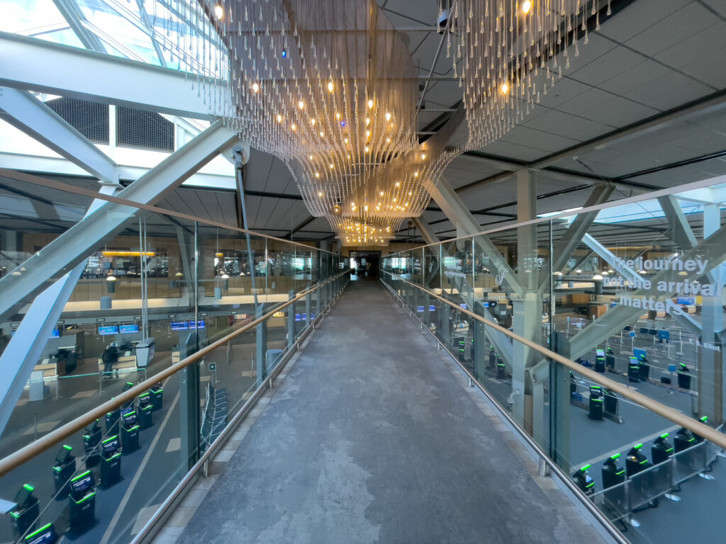 Inside the Fairmont Vancouver Airport hotel looking over a bridge into the airport terminal.