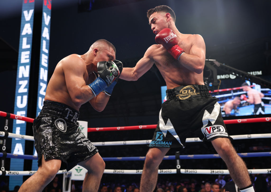 LOS ANGELES, CALIFORNIA - AUGUST 3: Isaac Cruz( black with silver shorts) and Jose Valenzuela (black with white shorts) during their WBA World Super Lightweight Titles Contest at BMO Stadium on August 3, 2024 in Los Angeles, California. (Photo by Mark Robinson/Matchroom Boxing/Getty Images)