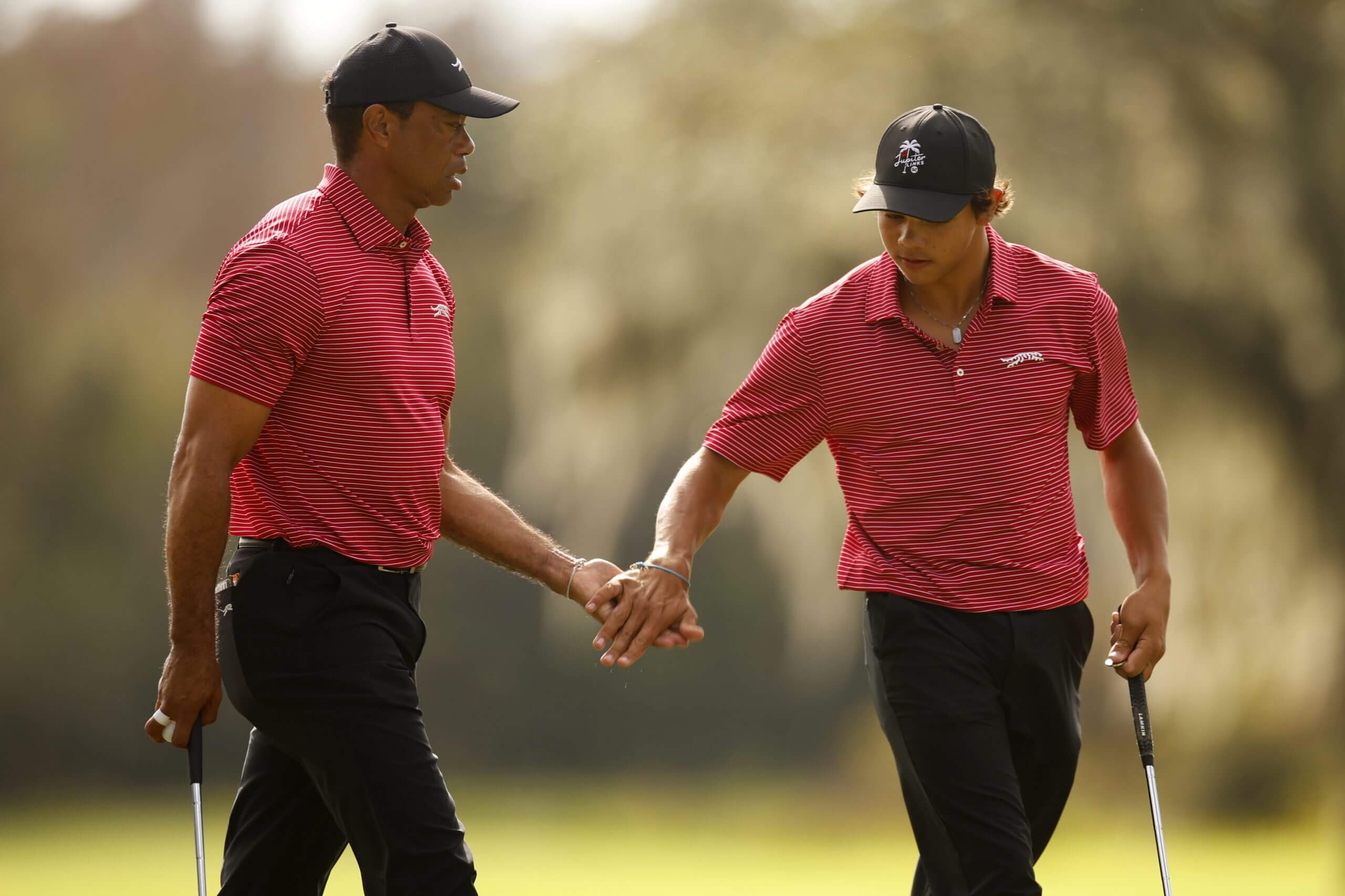 Tiger Woods and his son, Charlie, slap hands during the 2024 PNC Championship.