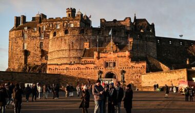This general view shows tourists outside Edinburgh Castle on December 30, 2025, ahead of the annual Hogmanay street party which culminates in a midnight fireworks display over the castle. An estimated 100,000 people from dozens of countries are expected in Edinburgh for the New Year events, the centrepiece of which is a street party and fireworks display on December 31. (Photo by Andy Buchanan / AFP via Getty Images)