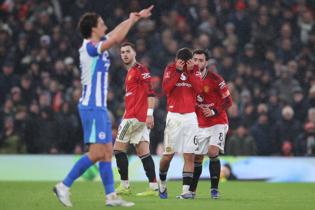 Shea Lacey covers his face after receiving a red card