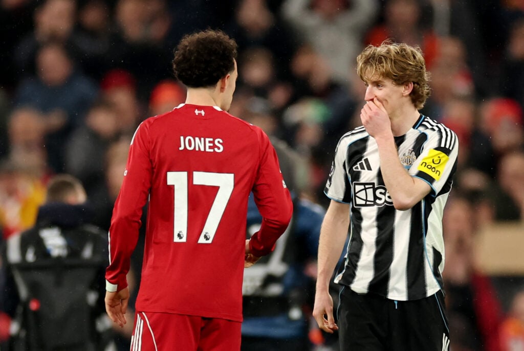Anthony Gordon and Curtis Jones chat on the pitch after Liverpool's Premier League win over Newcastle United at Anfield.