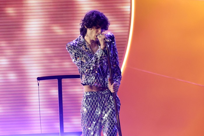 68th GRAMMY Awards - Show Sombr stood on stage holding a microphone close to his face.