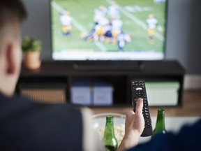 Young adult men friends watching American football