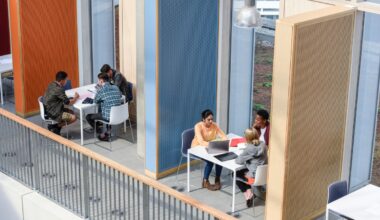 Groups of college students sitting in booths, discussing