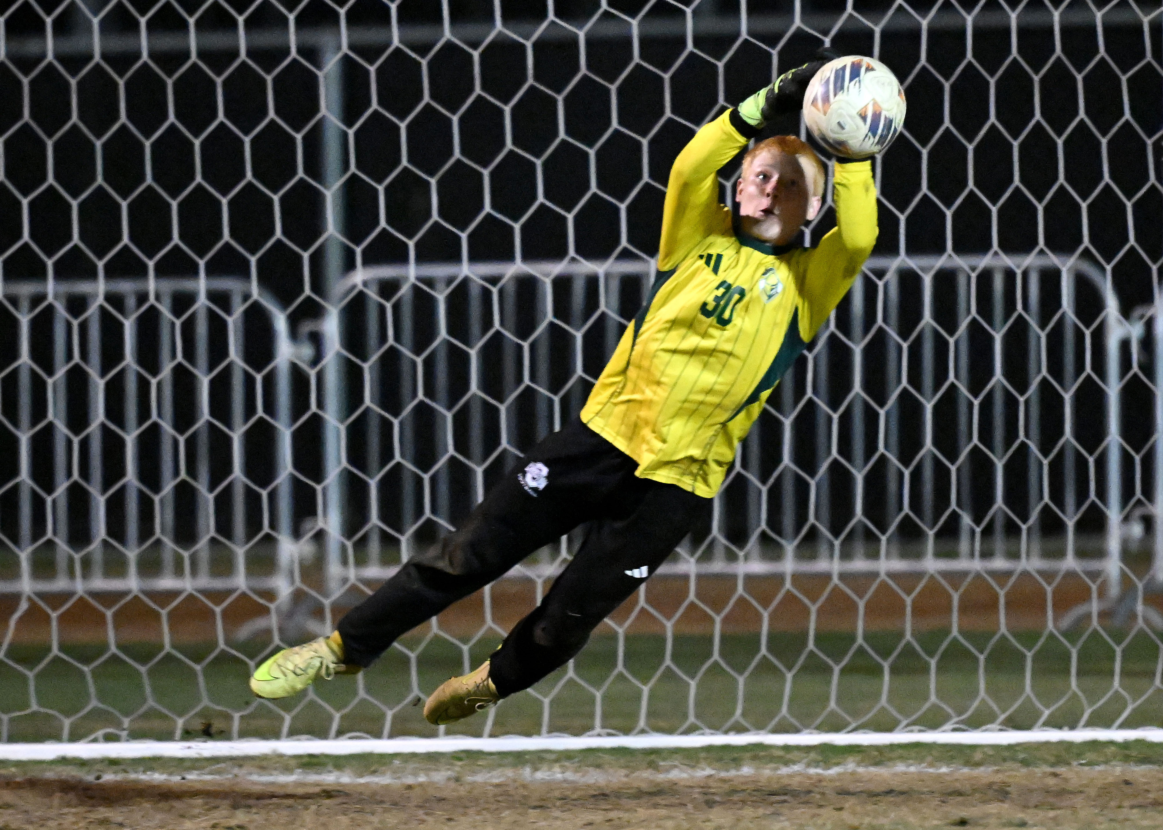 Ontario Christian goalkeeper Andrew Belden (30) makes a diving save...