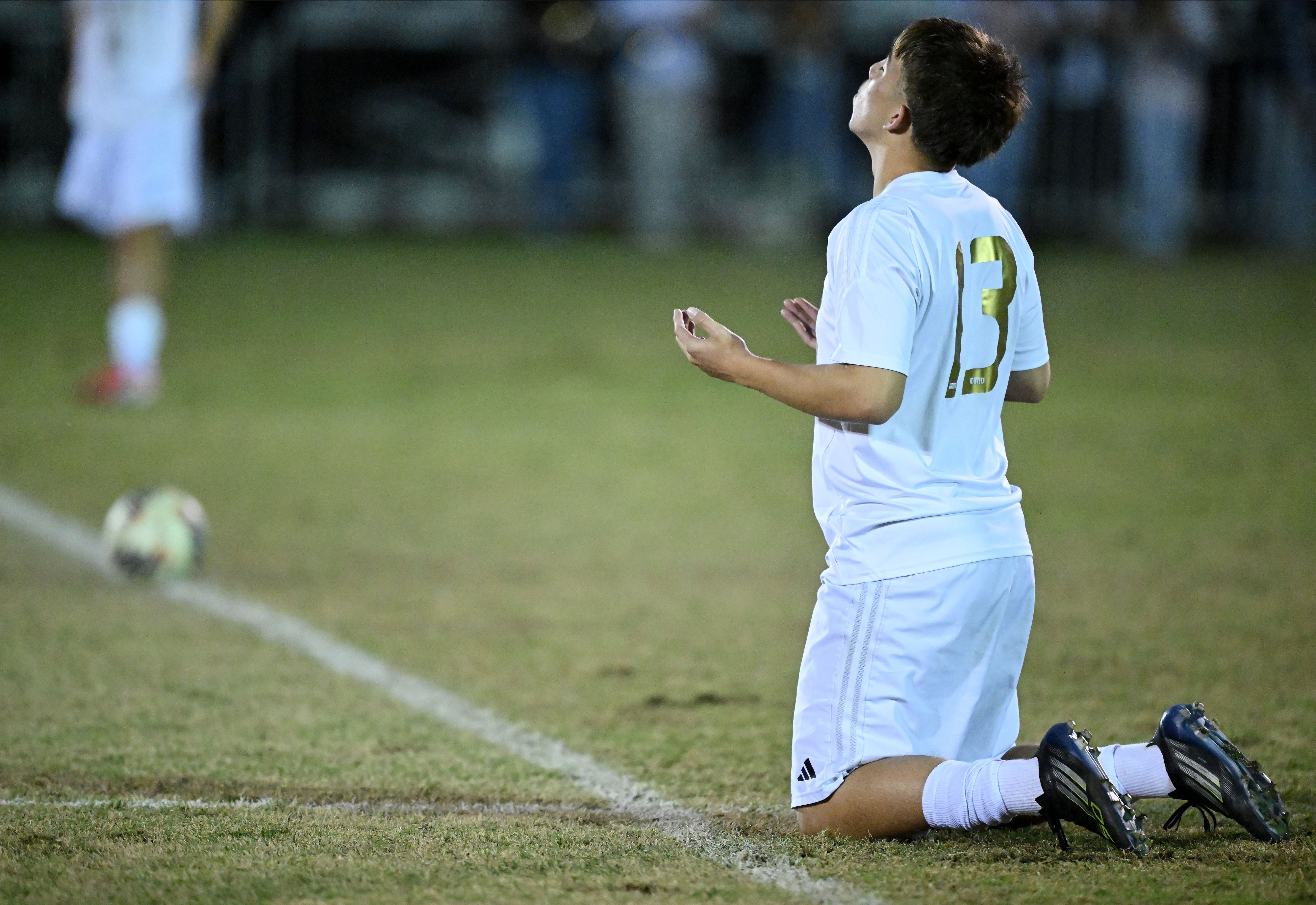 Animo Leadership forward Jeremiah Medrano (13) prays before the start...