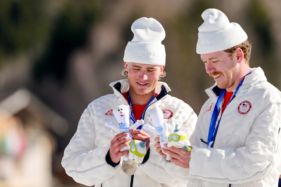 Ben Ogden and Gus Schumacher, of the United States, stand on the podium after winning the...
