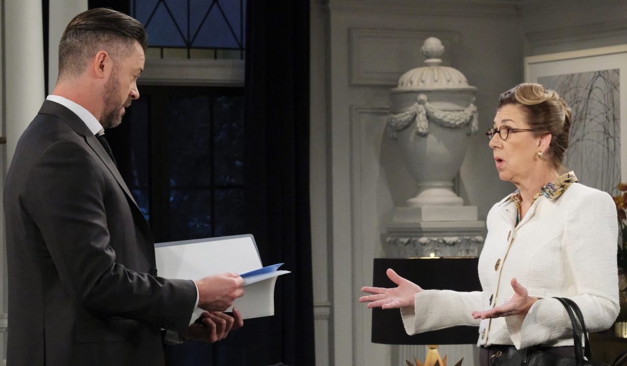 Days EJ is flipping through a packet of papers in his living room, while Rita talks to him, hands held palm up, questioningly