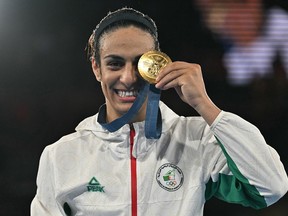 Algeria's Imane Khelif poses on the podium with the gold medal at the 2024 Paris Olympics. Getty Images