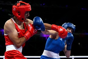 Algeria’s Imane Khelif (in red) punches Italy’s Angela Carini at the Paris Games.