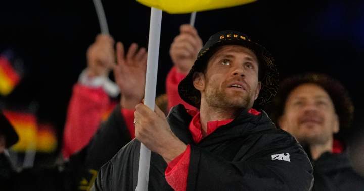 Leon Draisaitl carries flag for Germany at opening ceremony before Olympic debut - Edmonton