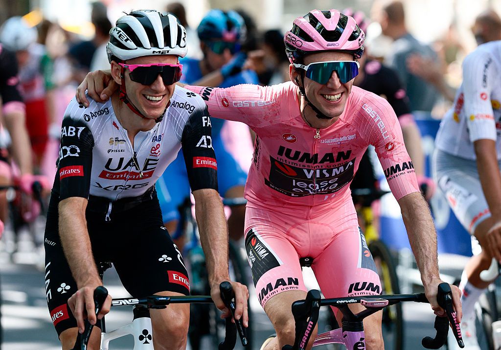 Adam Yates (l) celebrates with Simon Yates (r) as his brother heads towards victory in the 2025 Giro d'Italia