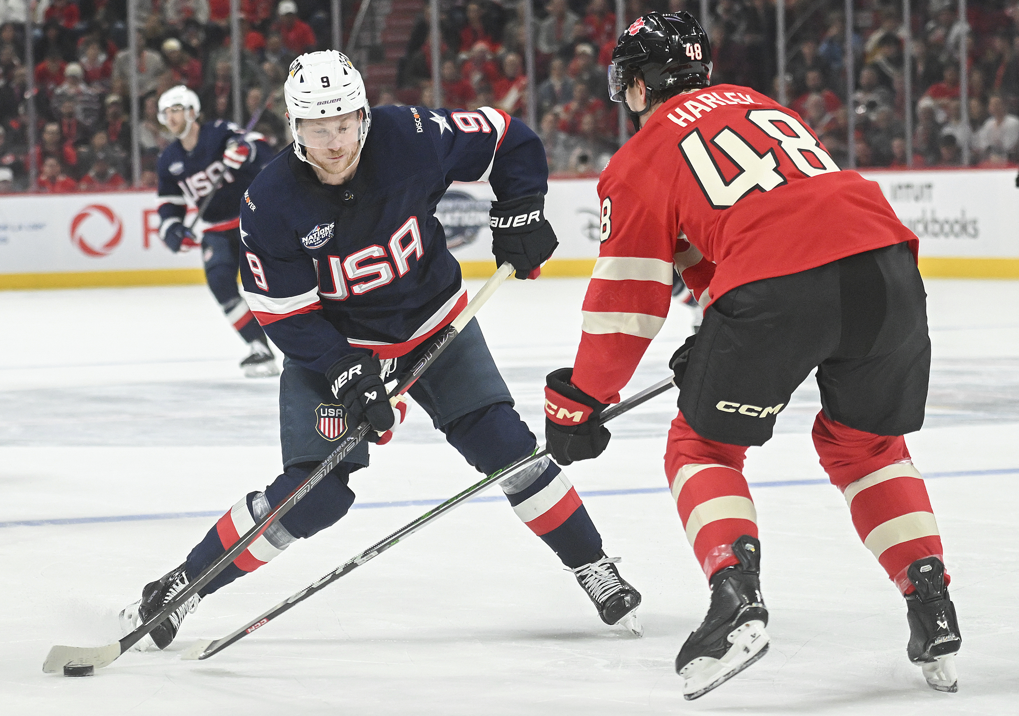United States' Jack Eichel (9) takes a shot as Canada's Thomas Harley (48) defends during second period 4 Nations Face-Off hockey action in Montreal, Saturday, February 15, 2025. (Christinne Muschi/The Canadian Press via AP)