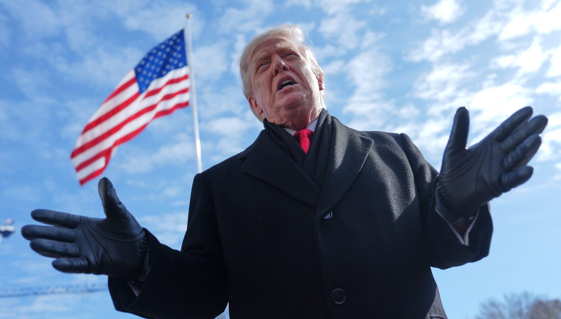 Photo of President Donald Trump speaking in front of an American flag.