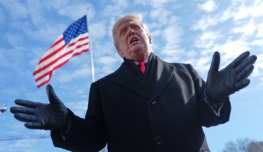 Photo of President Donald Trump speaking in front of an American flag.