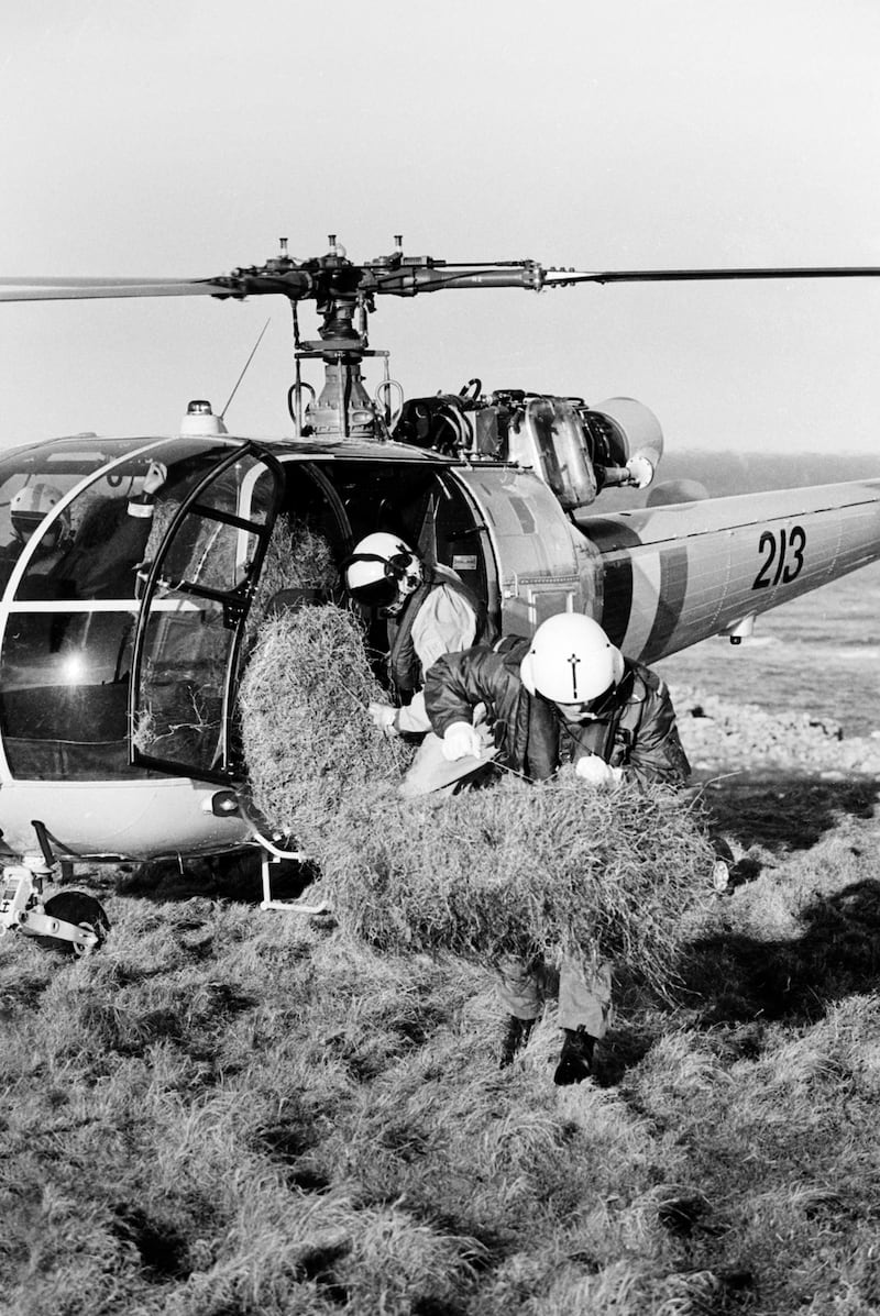 Lieut Mike Sullivan and airman Adrian Thompson of the Irish Air Corps deliver bales of hay to hungry sheep on Rathlin O'Birne Island in 1999 following a prolonged spell of bad weather. All photographs: Declan Doherty